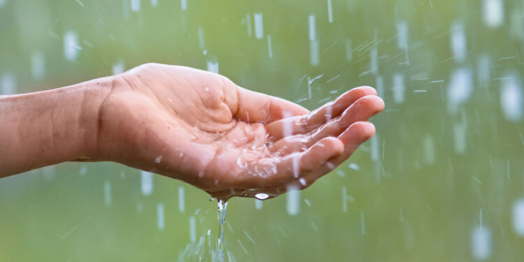 34839005 - water droplets falling into the hand